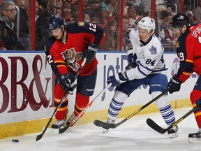 Mikhail Grabovski #84 of the Toronto Maple Leafs attempts to take the puck from Jack Skille #12 of the Florida Panthers.