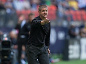 Vancouver Whitecaps' head coach Carl Robinson argues a call with the referee before being ejected from the pitch during first half MLS soccer action against the New York Red Bulls in Vancouver, Saturday, September 3, 2016.