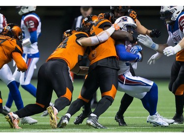Montreal Alouettes' Stefan Logan, right, is tackled by B.C. Lions' Solomon Elimimian during the first half of a CFL football game in Vancouver, B.C., on Friday September 9, 2016.