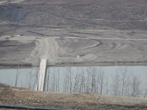 South facing view from the north bank looking down on the access bridge. Site C Dam site construction.