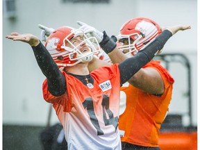 SURREY, BC: August 2, 2016 -- BC Lions Offensive Coordinator and Quarterbacks Coach Khari Jones, right and quarterback Travis Lulay, left during the team's practice at their facility in Surrey, B.C. Tuesday August 2, 2016.  (photo by Ric Ernst / PNG)  (Story by Mike Beamish)  TRAX #: 00044449A [PNG Merlin Archive]