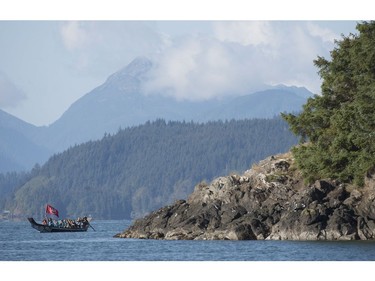 The Duke and Duchess of Cambridge paddle with a group in a traditional Haida canoe in the waters of Haida Gwaii, Friday, Sept. 30, 2016.