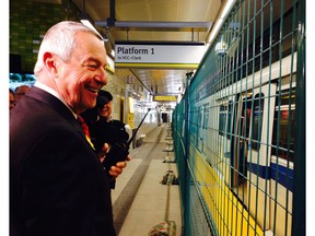 Peter Fassbender, the minister responsible for TransLink, questions the NDP's math on money matters ahead of the 2017 provincial election. Here he takes a look at some of the new cars purchased for the Evergreen Line, though a construction fence at the Moody Centre Station.