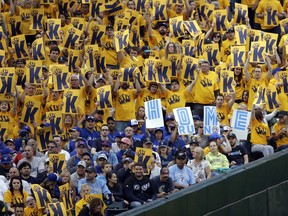Blue Jays fans hold up signs calling for a Jays' home run as they sit near Seattle Mariners fans in the "King's Court" area, dedicated to fans of Mariners starting pitcher Felix Hernandez, during a game at Safeco Field in 2015.