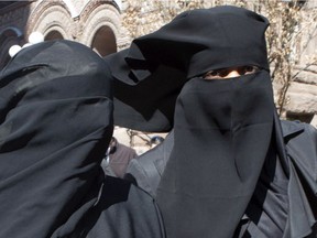 Even though Stephen Harper, who had called the niqab “anti-woman,” was defeated last October, most Canadians remain offended by the niqab. The case has never been subject to Charter arguments. Photo: Women wear niqabs outside a court house in Toronto.