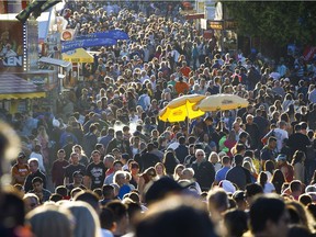Late evening light falls over crowds at the PNE on the Labour Day weekend as they fill the midway.