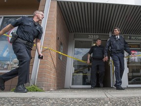 Police tape off a residence in the 3300-block Kingsway in Vancouver on April 14, 2014 after police shot a man who stabbed a woman and child.