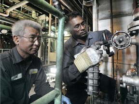 Ravi Thambirajah (r) and Andy Lau at work at thhe Creative Energy plant (the old Central Heat Distribution) in Vancouver, BC., April 22, 2015.