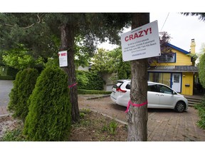 Point Grey Road residents were upset that the City of Vancouver reclaimed land for a sidewalk expansion — and now some of them fear they could be charged $80,000 a house to cover the cost of moving utility lines underground.