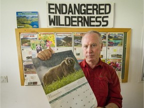 VANCOUVER, BC - SEPTEMBER 15, 2016,  -   Joe Foy, national campaign director, Wilderness Committee holding Canadian Wildlife Federation calendar at  in Vancouver, BC., September 15, 2016.  The Wilderness Committee is opposed to the grizzly trophy hunt but the Canadian Wildlife Federation represents hunters. (Arlen Redekop / PNG photo) (story Larry Pynn)