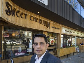Brij Chopra of Sweet Cherubim Organic & Natural Foods stands in front of his business on Commercial Drive in Vancouver on Tuesday. Many businesses on the Drive are angry after being given only a week's notice of B.C. Hydro work. Some are worried about spoiled product, others have had to cancel clients. Arlen Redekop/PNG
