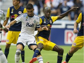Vancouver Whitecaps FC #77 Pedro Morales and New York Red Bulls #99 Bradley Wright-Phillips battle for the ball