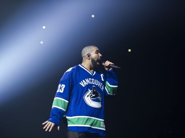 Drake performs on stage in a Vancouver Canucks jersey at Rogers Arena, Vancouver, September 17, 2016.