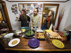 Dani Raath (left), rings the dinner bell with Fabian Low (middle) and Jen Muranetz (right) to call members of the Lounge to the dining room.