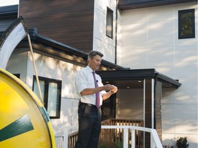 Vancouver Mayor Gregor Robertson reads out the winning ticket number for the 2016 PNE Prize Home on Monday.