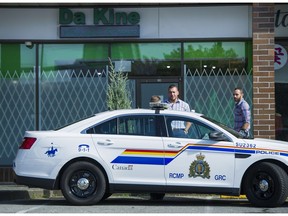 File: A Surrey RCMP car is parked outside Da Kine marijuana shop in Surrey as officers await a warrant to raid the business.