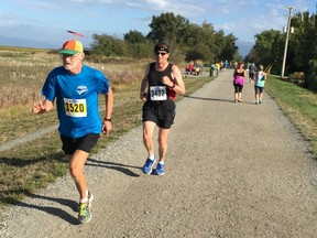 Dennis Keithley of Garibaldi Highlands, with his propeller-top hat, stays a few feet ahead of Lindsay Darling of Richmond in Sunday's Forever Young 8K race at Garry Point Park in Richmond. The second annual event, for runners and walkers 55 and older, attracted 325 entries.
