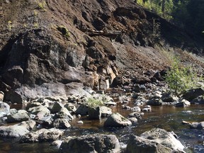 Mine debris and waste from a tailings dump eroding into the Jordan River, once a stream whose abundant salmon runs sustained the Pacheedaht people who trace their ancestral origins from near here.