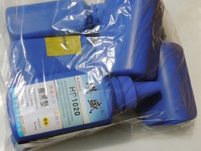 This June 2016 photo provided by the Royal Canadian Mounted Police shows printer ink bottles containing carfentanil imported from China, in Vancouver.
