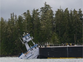 A tug and barge that carries petroleum products to and from Alaska through B.C.s Inside Passage has run aground near Bella Bella.  The Canadian Coast Guard confirms the Nathan E. Stewart, an articulated tug/barge owned by the Texas-based Kirby Corporation, ran aground at Edge Reef in Seaforth Channel just after 1 a.m. Thursday. The coast guard says the 287-foot long fuel barge was empty, but the 100-foot tug itself is leaking diesel fuel. People on the scene at noon said that the tug was half under water and on its way to sinking completely. MANDATORY PHOTO CREDIT: Norman Fox [PNG Merlin Archive]