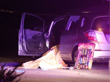 A blanket covers the body of a man who died at the scene of a shooting in Surrey on Friday night.