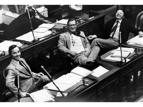 A last-day lark in the B.C. legislature in 1975 had Social Credit MLA Don Phillips wearing a 'I Can't Buy Coverage T-shirt.' Joining in the joke during discussion of Transport Minister Robert Strachan's estimates are Socred leader Bill Bennett, left, MLA Jim Chabot.