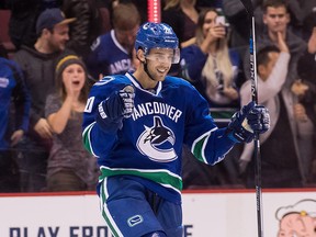 Brandon Sutter #20 of the Vancouver Canucks scores the game winning goal against goaltender Chad Johnson #31 of Calgary Flames during a shootout of their NHL game at Rogers Arena on October 15, 2016.