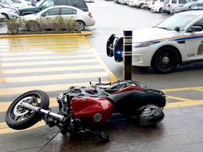 A motorcycle is ditched outside Willowbrook Mall in Langley.  RCMP searched the area for a man who jumped the border at the Aldergrove crossing.