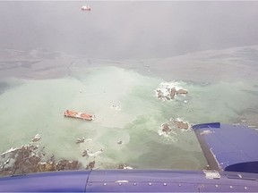 A tug boat that ran aground near British Columbia's Great Bear Rainforest is seen on Thursday, Oct. 13, 2016 in this aerial handout photo. A tug boat that ran aground and sank near British Columbia's Great Bear Rainforest is leaking diesel fuel, which the coast guard says is expected to dissipate.