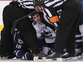 Alexandre Burrows of the Canucks looks up to officials after a tussle with Bryan Little of the Winnipeg Jets.