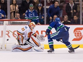 Brandon Sutter #20 of the Vancouver Canucks scores the game winning goal against goaltender Chad Johnson #31 of Calgary Flames during a shootout of their NHL game at Rogers Arena.