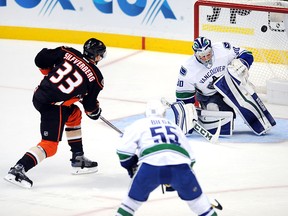 Vancouver Canucks goalie Ryan Miller (30) deflects a shot by Anaheim Ducks Jakon Silfverberg (33) in the first period of a game played on October 23, 2016 played at the Honda Center in Anaheim, CA.