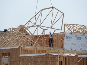 Construction workers are busy across the country building new houses, despite a slow-down in Toronto and sales easing off in Vancouver.