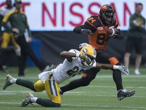 Edmonton Eskimos defensive back Marcell Young  tries to catch BC Lions slotback Emmanuel Arceneaux during the first half of Saturday's game at B.C. Place.