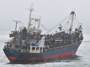 Hundreds crowd the deck of the MV Sun Sea off the coast of B.C. in August 2010. — Canadian Forces Combat Camera files