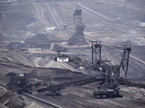 Giant machines dig for brown coal at the open-cast mining Garzweiler near the city of Grevenbroich, western Germany.