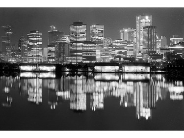 Downtown Vancouver buildings reflected in Coal Harbour. January 10, 1977.