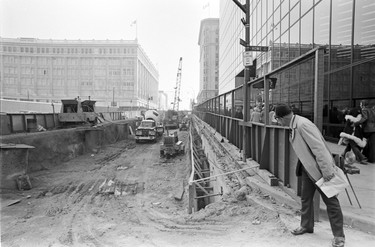 West Georgia Street being dug up due to construction of the Pacific Centre Mall. The Hudson’s Bay building. October 17, 1972.