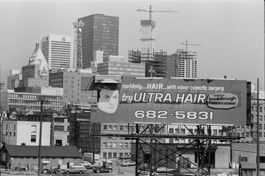 The iconic Ultra Hair billboard flips its lid at the north end of the Cambie Street bridge, but it would soon be removed under a new civic bylaw. July 10, 1975.
