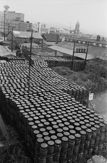 Stacks of barrels at Sweeney Cooperage, located under the Cambie Street Bridge on the north shore of False Creek. December 17, 1977.