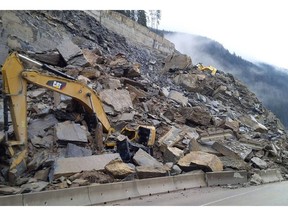 Construction equipment sit buried by a rock slide that closed the Trans-Canada Highway west of Field, B.C. in this handout photo. The highway didn't reopen until more than a week later.