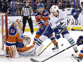 Vancouver Canucks winger Alex Grenier is stopped by Edmonton Oilers goalie Cam Talbot during an NHL game last season at Edmonton’s Rexall Place.
