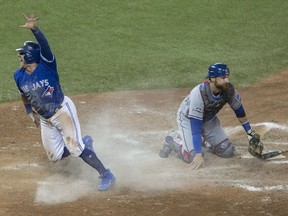 More than seven million Canadians watched Toronto Blue Jay Josh Donaldson celebrate after scoring the winning run in the 10th inning of Sunday’s American League Division Series over catcher Jonathan Lucroy (right) and his Texas Rangers.