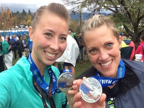 Katya Holloway, right, and Christina Brownlow proudly display their medals after finishing Sunday's Oasis Rock 'N' Roll Vancouver half-marathon. Holloway then sat down and wrote about crushing her second half-marathon.
