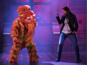 The lion dancer and Andrea Yu as Lauren in  King of the Yees, on at the Gateway Theatre in Richmond.