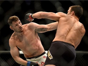 Michael Bisping, left, fights Luke Rockhold during a UFC 199 at the Forum in Inglewood, Calif., Saturday June 4, 2016.