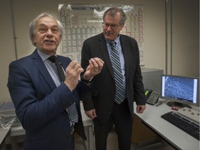 Pierre Lapointe, Pres and CEO of FPInnovations (left) talks with Honourable Steve Thomson, minister of forests, lands and natural operations, inside FPInnovations labs at UBC in Vancouver, BC, April 23, 2014.