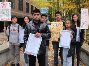 Secondary school student representatives gathered outside the Vancouver school board office on Friday to release a joint declaration calling for reinstatement of school trustees. Among them were Caitlin Wong (second from right), Hazel Pangilian (far right) and Ronic Parmar (centre-foreground).
