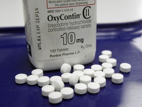 FILE - OxyContin pills arranged for a photo at a pharmacy