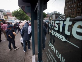 People gather outside supervised injection site, Insite, during a demonstration in the Downtown Eastside of Vancouver, B.C., on Wednesday June 8, 2016. Two drug users' advocacy groups are calling on the B.C. government to open more safe injection sites to help prevent fatal overdoses.